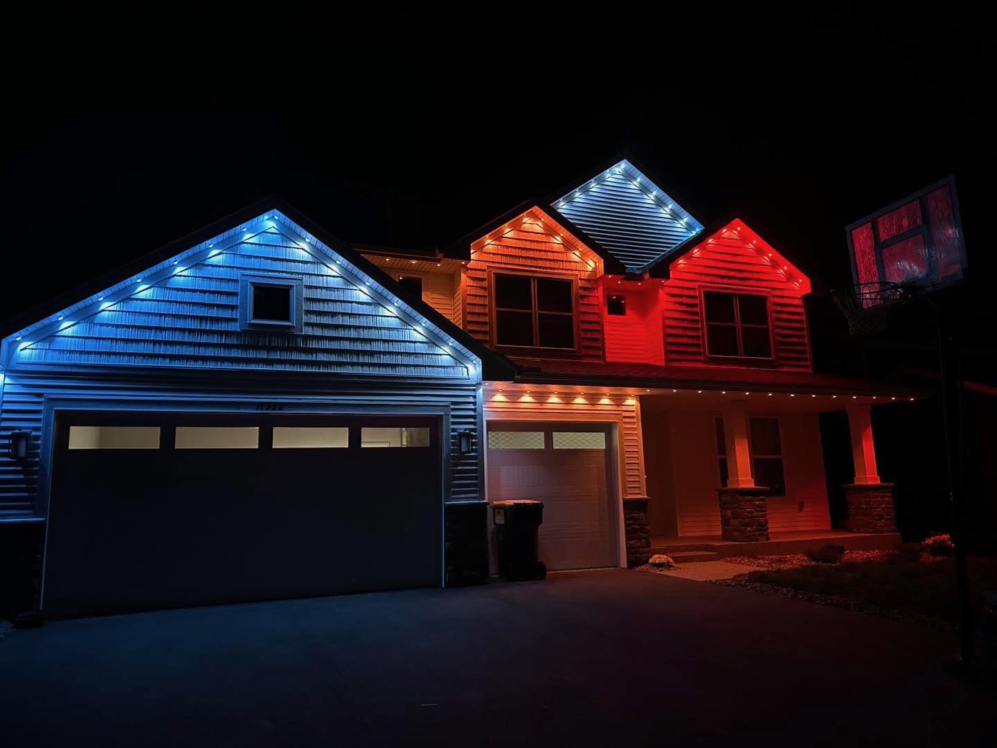 Home with blue, orange and red permanent gable lighting
